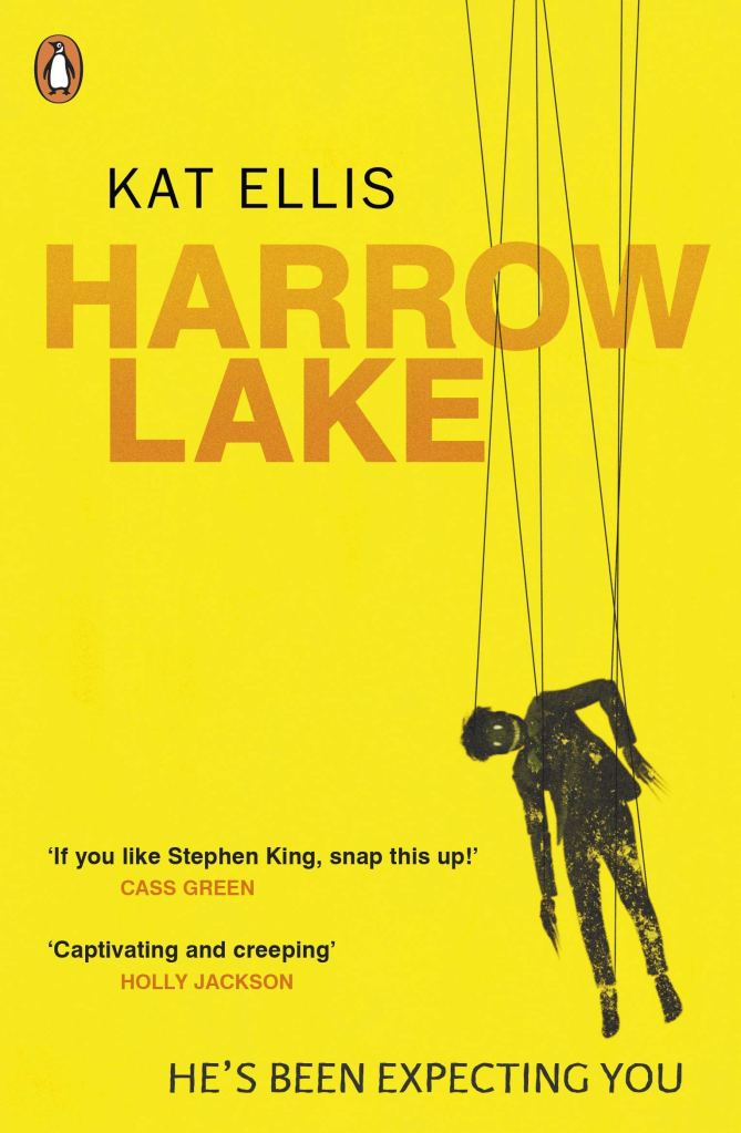 Harrow Lake by Kat Ellis, UK cover, yellow background, orange title text, with black stylised figure of Mister Jitters puppet hanging from strings.